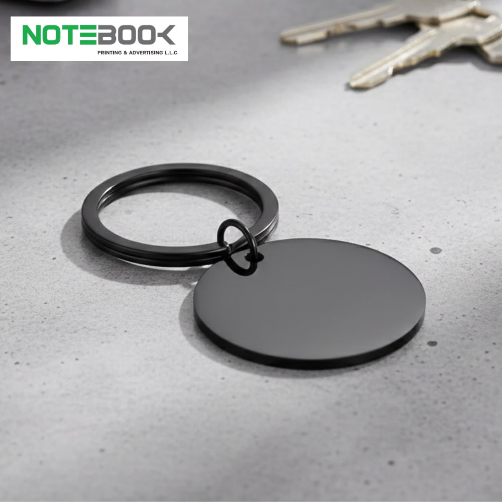 Black Round Stainless Steel Keychain with custom engraving for corporate gifts by Notebook Advertising LLC Dubai